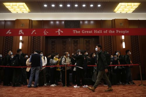 Journalists wait in line ahead of the closing ceremony of the 20th National Congress of China's ruling Communist Party at the Great Hall of the People in Beijing, Saturday, Oct. 22, 2022. 