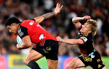 Leicester Fainga&#x27;anuku of the Crusaders evades Damian McKenzie of the Chiefs.
