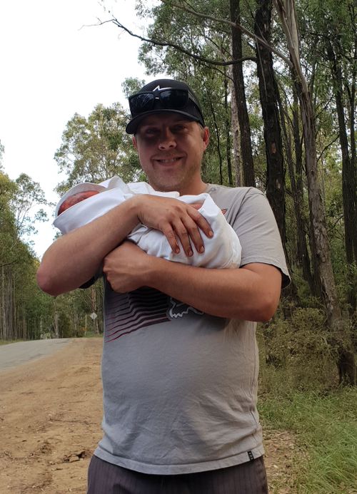 Proud dad Jarrad holding baby Ivy who was born by the side of the road near Cessnock last Tuesday (NSW AMBULANCE)