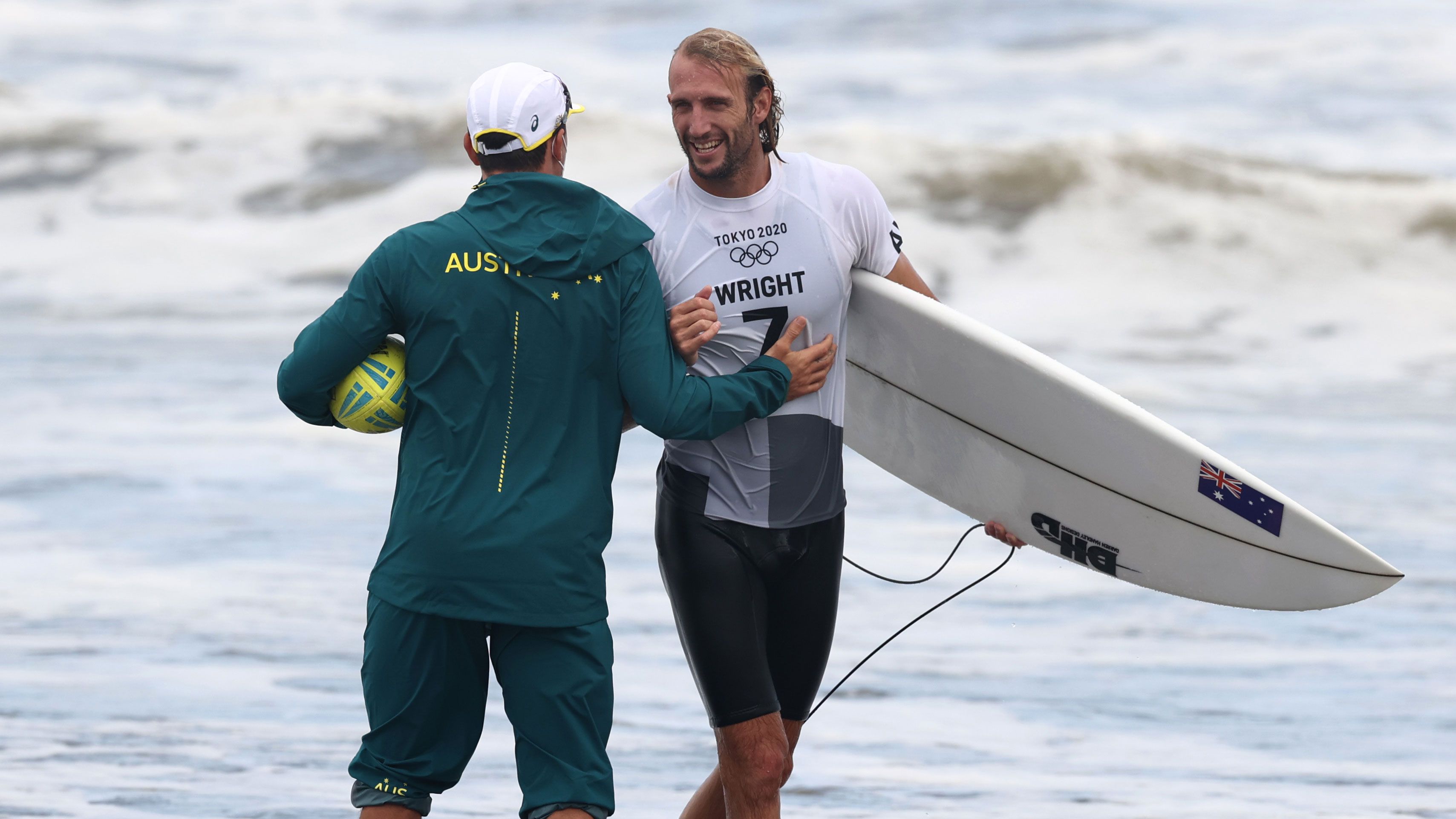 Owen Wright celebrates a victory in the Olympics surfing competition.
