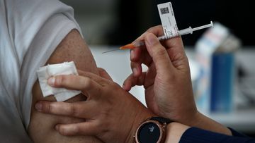 A nurse administers the Pfizer vaccine to a client at a pop-up clinic at the Lebanese Muslim Association (LMA) in Lakemba last month.