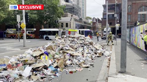 Garbage truck dumps rubbish after fire.