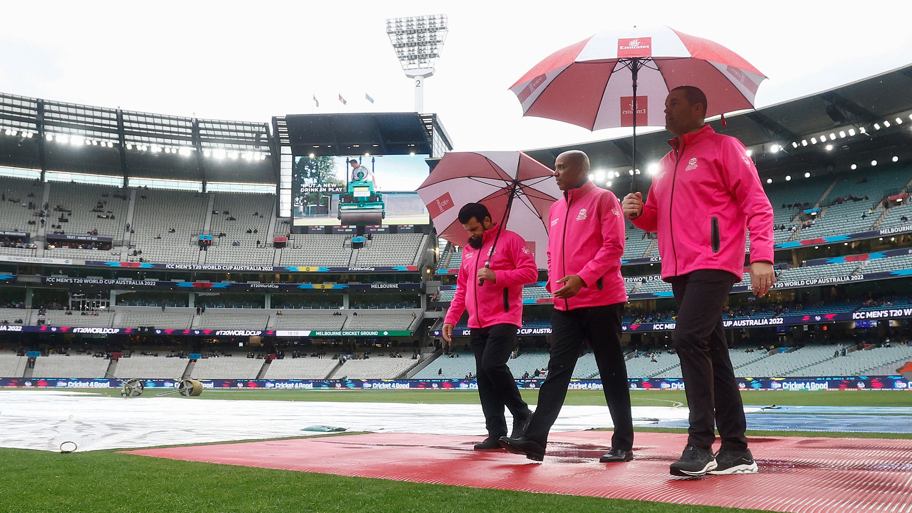The umpires inspect the field as rain delays play during the ICC Men&#x27;s T20 World Cup match between England and Australia at Melbourne Cricket Ground on October 28, 2022 in Melbourne, Australia. (Photo by Daniel Pockett-ICC/ICC via Getty Images)