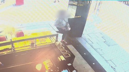 A man with an axe has terrified Foot Locker staff during an alleged daylight robbery at a store in Adelaide's CBD.