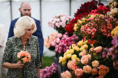 Queen Camilla looks at a flower display during a visit to Sandringham Flower Show at Sandringham House on July 26, 2023 in King's Lynn, England.