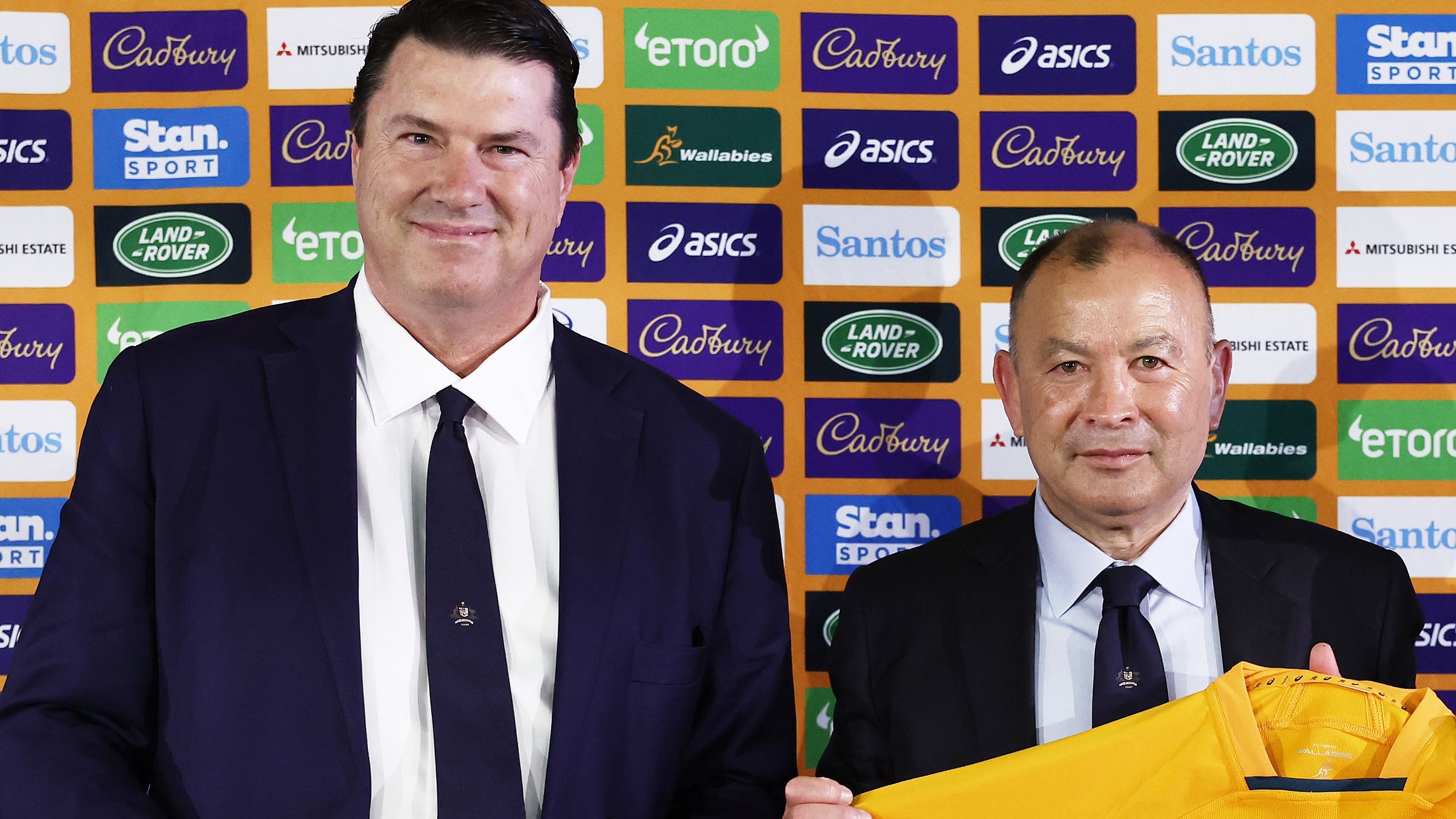 Wallabies coach Eddie Jones (middle) poses alongside Rugby Australia Chairman Hamish McLennan (left) and former Rugby Australia CEO Andy Marinos (right) during a press conference at Matraville Sports High School.