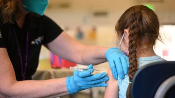 A nurse administers a pediatric dose of the Covid-19 vaccine to a girl at a L.A. Care Health Plan vaccination clinic at Los Angeles Mission College in the Sylmar neighborhood in Los Angeles, California, January 19, 2022 