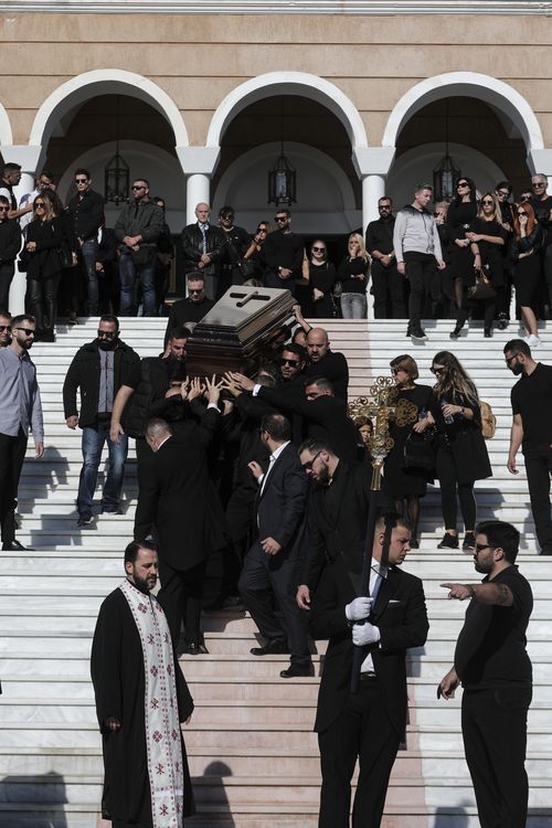 The coffin is carried down the steps of Saint Nektarios Church in Athens.