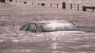 Two men have been pulled from a car trapped in floodwater at East Gippsland in Victoria. 
