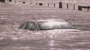 Two men have been pulled from a car trapped in floodwater at East Gippsland in Victoria. 