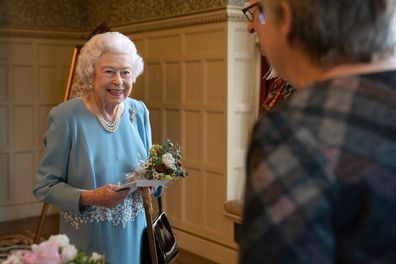 Queen Elizabeth II talks to members of the West Norfolk Befriending Society, during a reception in the Ballroom of Sandringham House, which is the Queen's Norfolk residence