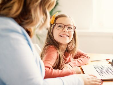Mother and daughter Having fun with laptop at home