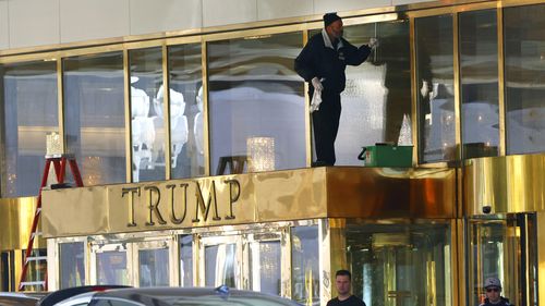 A worker cleans glass windows at Trump International Hotel, on Thursday, Jan. 2, 2025, in Las Vegas. (Bizuayehu Tesfaye/Las Vegas Review-Journal via AP)