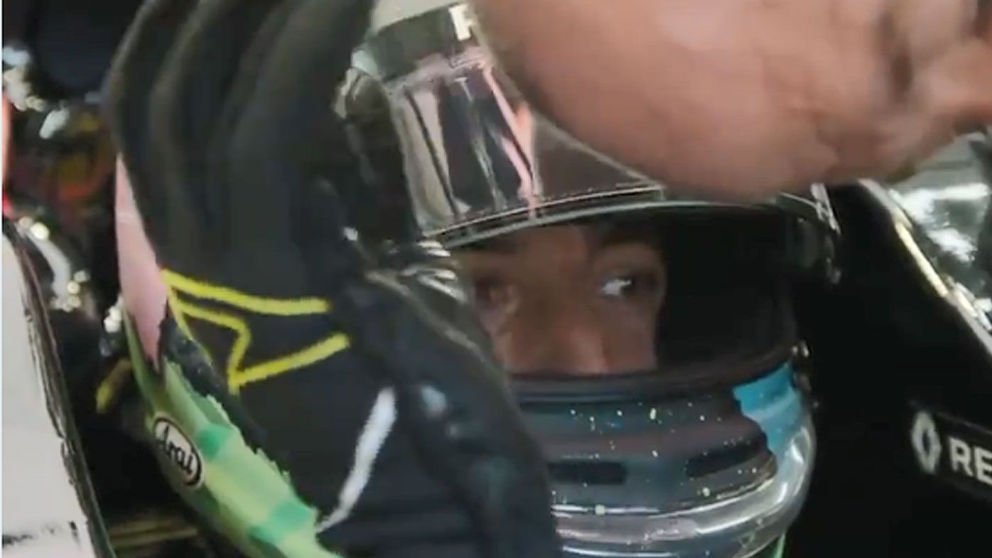Daniel Ricciardo rubs the head of his mechanic