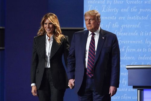 President Donald Trump and first lady Melania Trump hold hands on stage after the first presidential debate at Case Western University and Cleveland Clinic, in Cleveland, Ohio