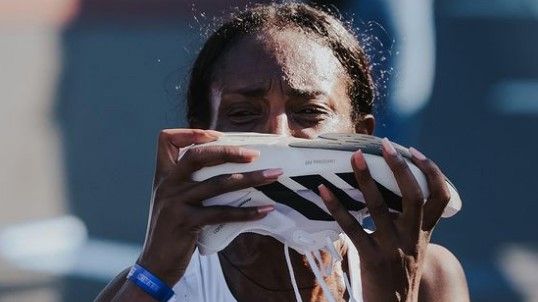 Tigst Assefa kisses her shoe after obliterating the women&#x27;s marathon record.