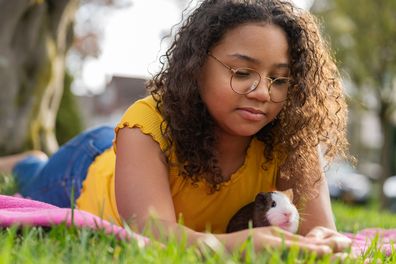 Girl with pet guinea pig