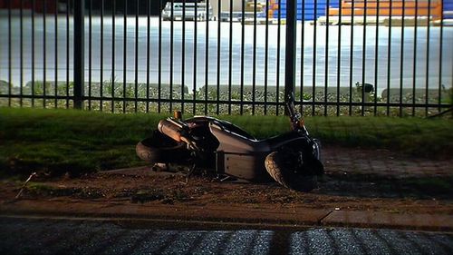 The scooter lying on the ground after being rammed by the taxi.
