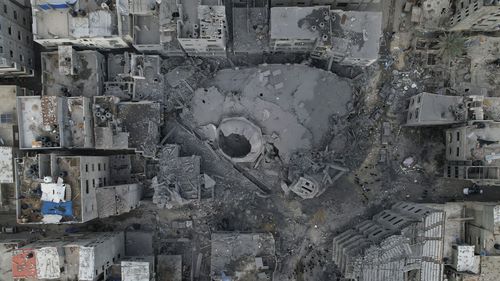The rubble of a mosque, destroyed in an Israeli airstrike, is seen at Shati refugee camp in Gaza City early Monday, Oct. 9, 2023. Israel's military battled to drive Hamas fighters out of southern towns and seal its borders Monday as it pounded the Gaza Strip.