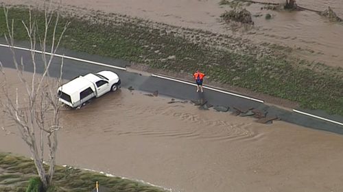 A car appears to be stuck in floodwaters at Laravale. (9NEWS)