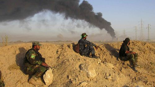 Smoke rises from Islamic State group positions after an airstrike by U.S.-led coalition warplanes in Fallujah, Iraq. (AAP)