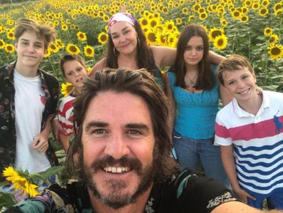 Kate Langbroek and her family in a field of sunflowers in Italy