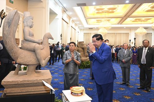 Cambodian Prime Minister Hun Sen, centre right, prays together with his minister of Culture and Fine Arts Phoeung Sackona, centre left, in front of a sandstone statue at Peace Palace, in Phnom Penh, Cambodia, Friday, March 17, 2023. 