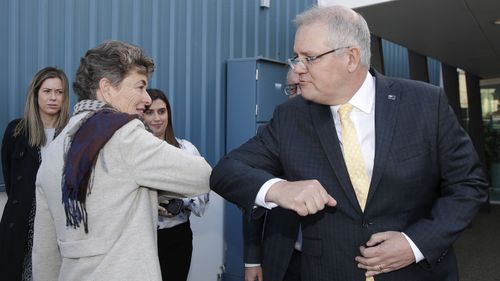 Scott Morrison bumps elbows with Liberal candidate Fiona Kotvojs.