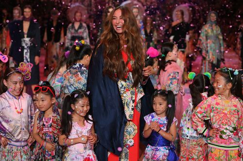 The show closed out with a shower of cherry blossoms before Franks herself appeared leading a troupe of children dressed in her designs. Picture: AAP