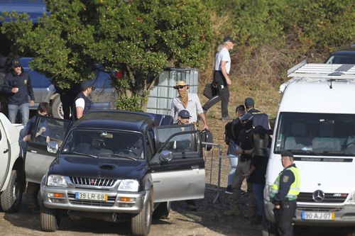 Police search teams set out from an operation tent near Barragem do Arade, Portugal, Wednesday May 24, 2023. 