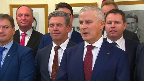 Michael McCormack surrounded by his Nationals colleagues and outgoing leader Barnaby Joyce in Canberra this morning. (9NEWS)