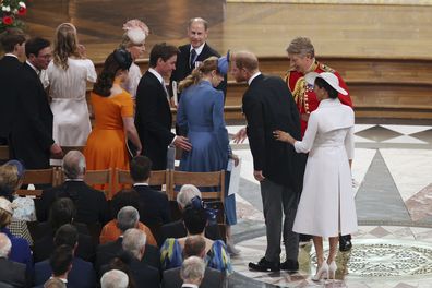 Prince Harry and Meghan Markle greet Princess Eugenie and Beatrice in their seats for the Service of Thanksgiving.