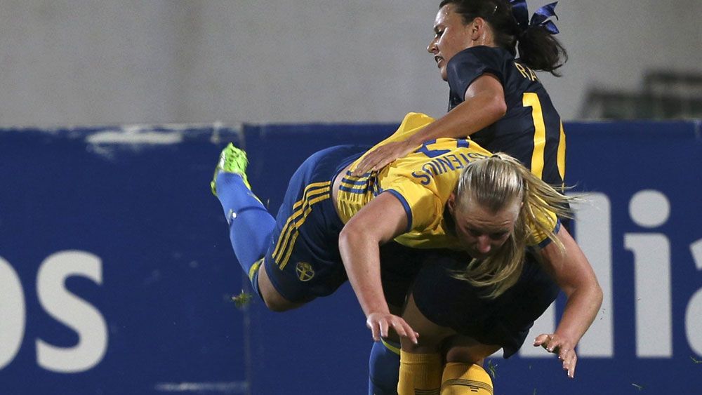 Australia's Hayley Raso and Sweden's Stina Blackstenius pulled no punches in the Algarve Cup. (AAP)