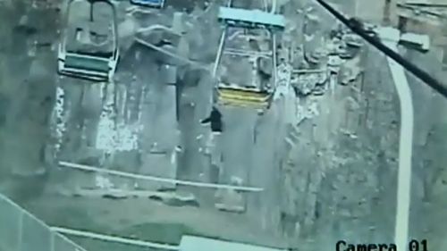 CCTV cameras recorded a man jumping from a chairlift over a tiger enclosure. (9NEWS)