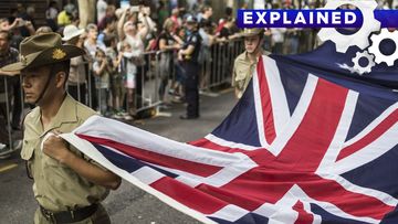 Soldiers carrying an Australian flag during an Anzac Day parade.