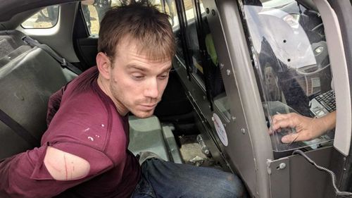 Travis Reinking was arrested after a 24-hour manhunt. (AP/AAP)