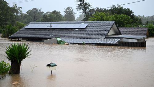 Homes were inundated by flood water yesterday in Goodna, west of Brisbane.