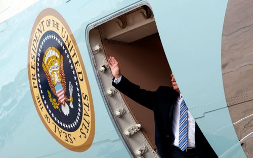 Trump waves as he boards Air Force One at Andrews Air Force Base.