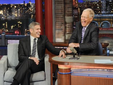 George Clooney handcuffs himself to Dave in an attempt to keep Dave from leaving the show, on the Late Show with David Letterman, Thursday May 14, 2015 on the CBS Television Network. 