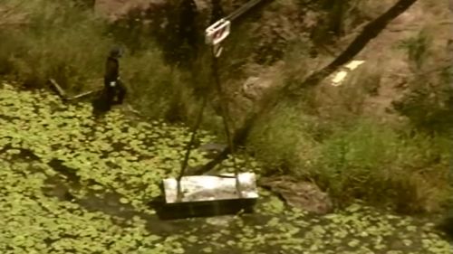 The box is winched from the dam. 