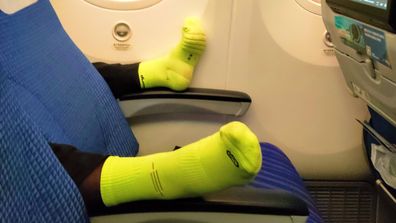 Person&#x27;s feet on plane 