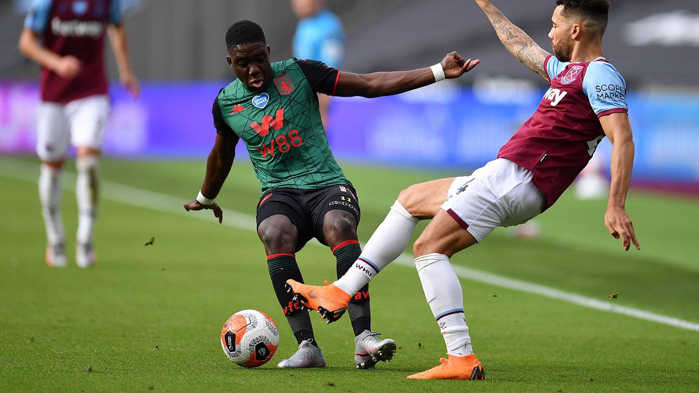 Marvelous Nakamba of Aston Villa battles for possession with Ryan Fredericks of West Ham United.