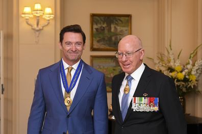 Australian Governor-General David Hurley (right) poses for photographs with Australian actor Hugh Jackman after he was awarded the Order of Australia