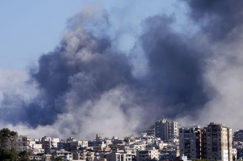 Smoke rises between buildings hit in Israeli airstrikes in Hosh neighbourhood, in Tyre, south Lebanon