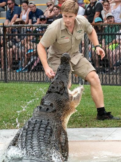 Robert Irwin feeding a crocodile at Australia Zoo