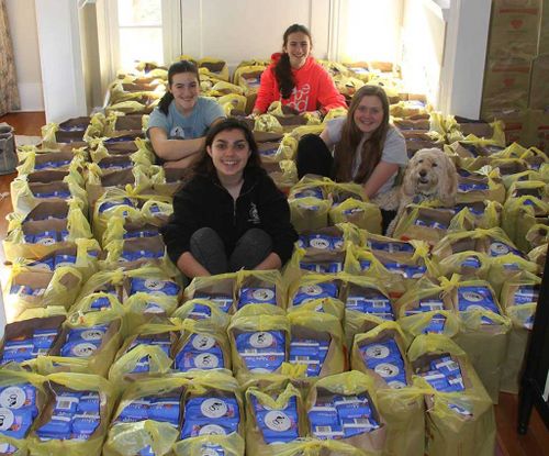 The girls with just a few of their many donations. (Image: Facebook/Girls Helping Girls Period)