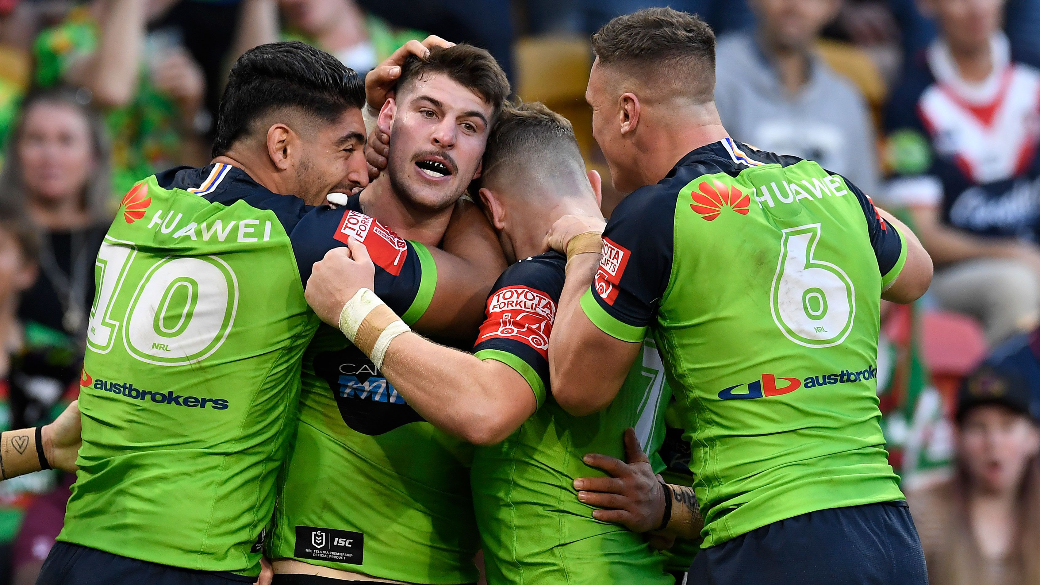 Curtis Scott celebrates with Raiders teammates after scoring a try.