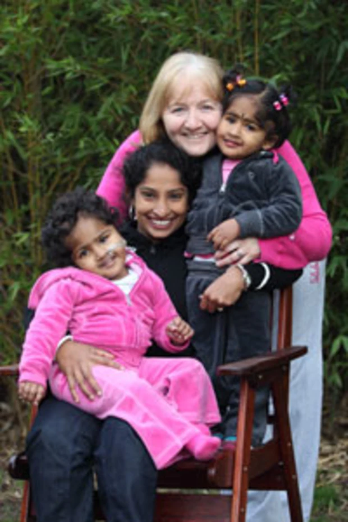 Formerly conjoined twins Krishna (left) and Trishna with their Bangladeshi mother, Lovely Goldar, and their Australian foster mother, Moira Kelly.