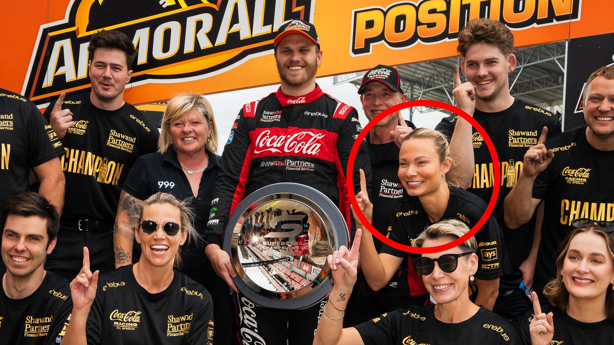 Brodie Kostecki holds the Supercars pole position award alongside Erebus Motorsport team owner Betty Klimenko and former general manager Shannen Kiely (circled).