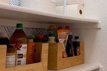 Paper towel storage in pantry made with tension rods.